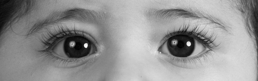 Black and white photo crop of an infant's eye.